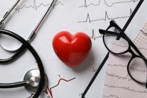 Medical concept with heart and electrocardiogram results, close up